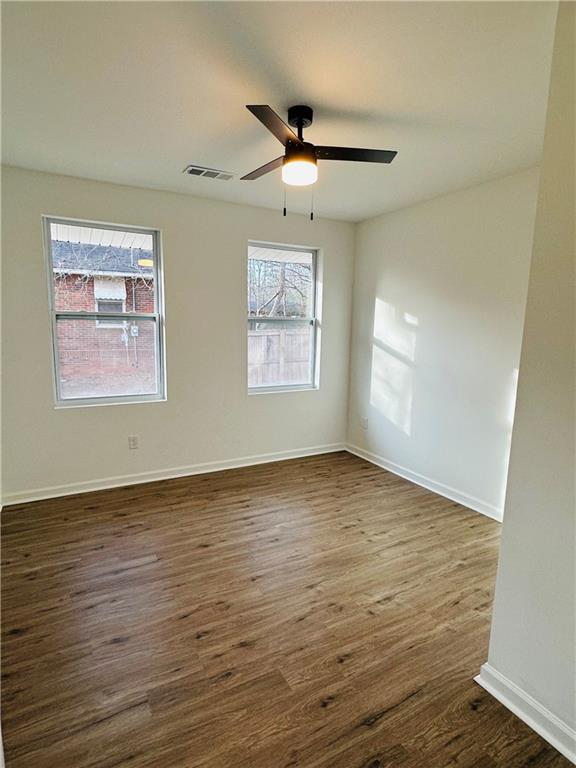 25 4th Street Gainesville, GA 30504 - Photo 9 of 20 a view of an empty room with wooden floor and a window