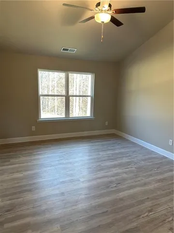 a bathroom with a granite countertop toilet and sink