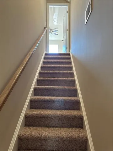a large kitchen with granite countertop a stove and a wooden floor