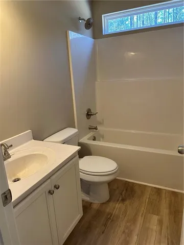 an empty room with wooden floor and a window