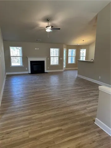 a view of a room with wooden floor and chandelier