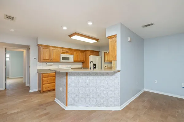 view of living room with granite countertop cabinets and stove top oven