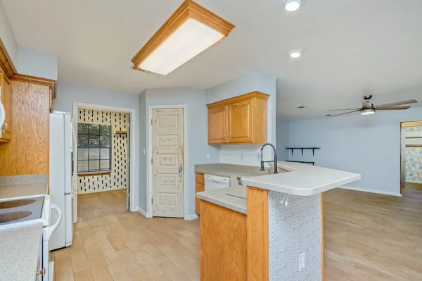 a kitchen with a sink a refrigerator and a stove