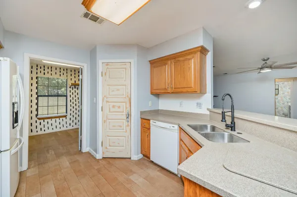 a kitchen that has a sink and a stove in it