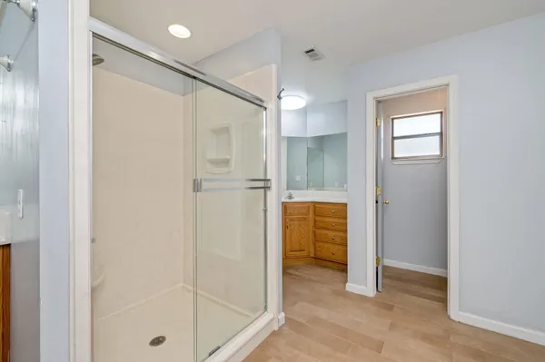 a bathroom with a shower and a glass door