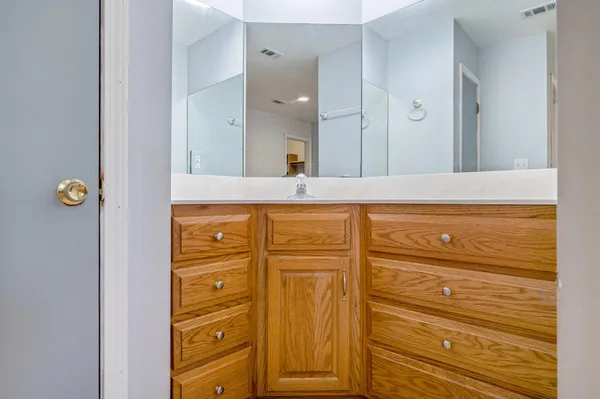 a bathroom with a sink a mirror and shower