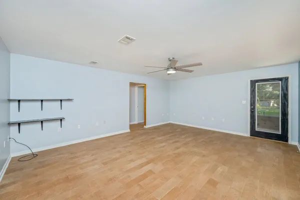 a view of an empty room with closet area