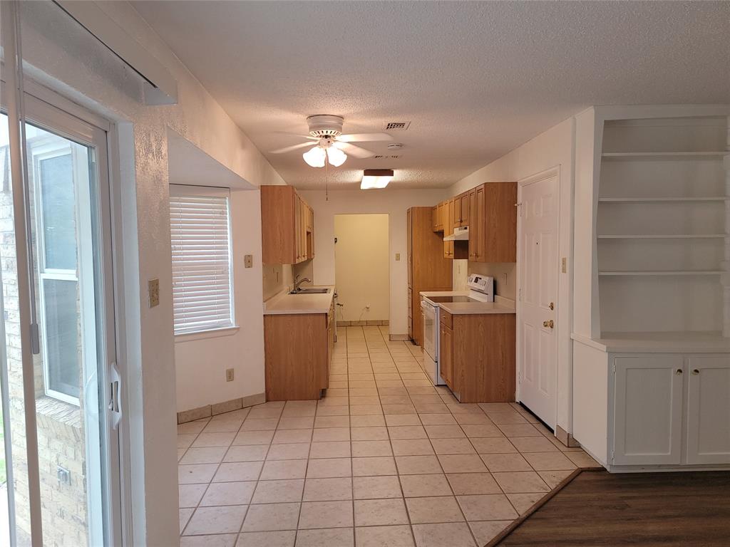 1000 Springdale Road Bedford, TX 76021 - Photo 10 of 36 Kitchen and breakfast nook open to living room.