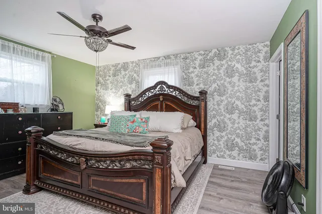 a bedroom with a bed and a chandelier