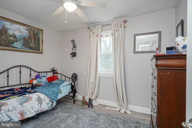 a bedroom with bed and a chandelier