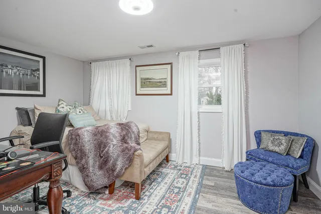 a living room with furniture rug and window