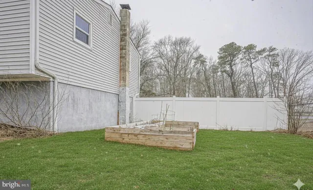 a view of a backyard with wooden fence