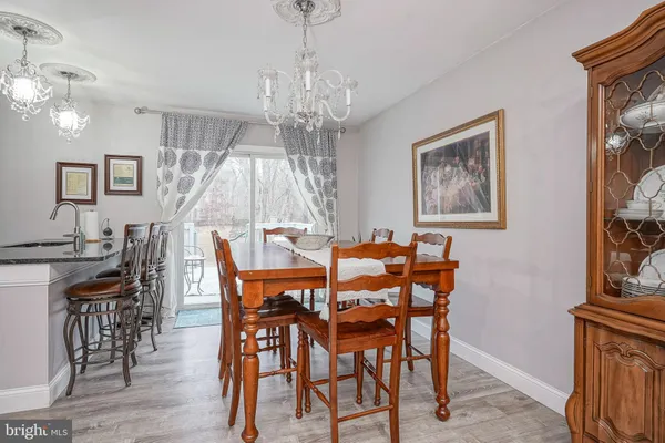 a view of a dining room with furniture wooden floor and chandelier