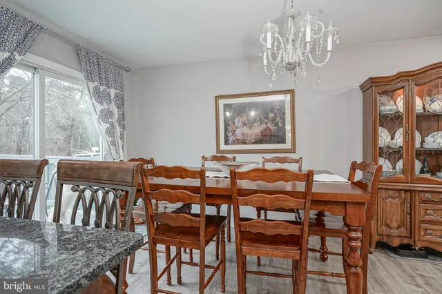 a view of a dining room with furniture wooden floor and chandelier