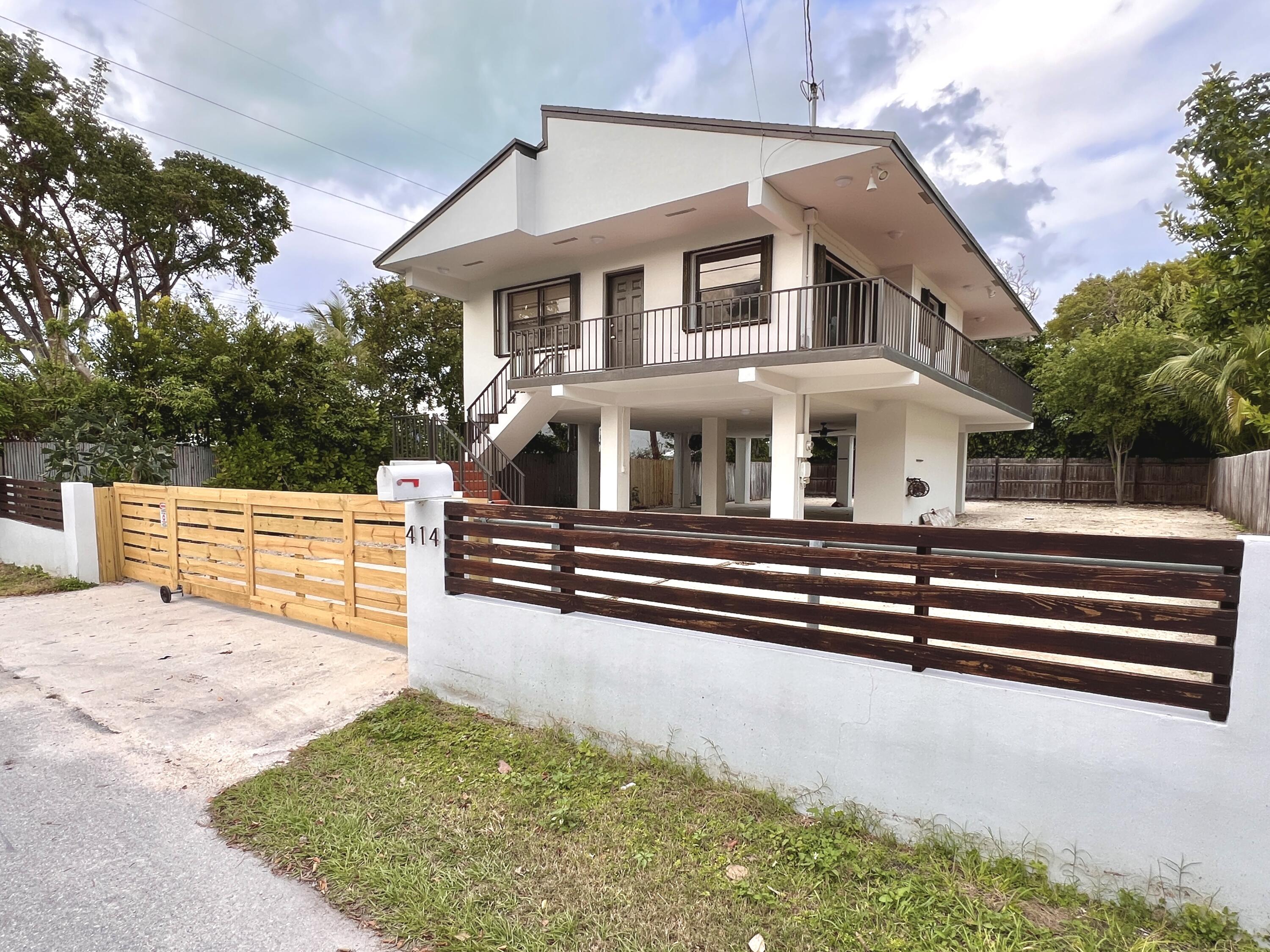 a view of house with yard and sitting area
