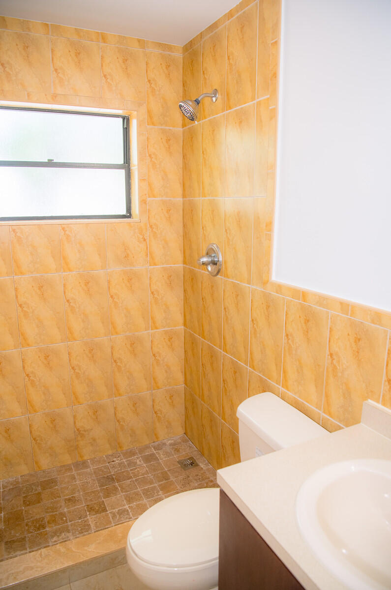 414 Coconut Drive Key Largo, FL 33037 - Photo 13 of 36 a bathroom with a sink a toilet and shower