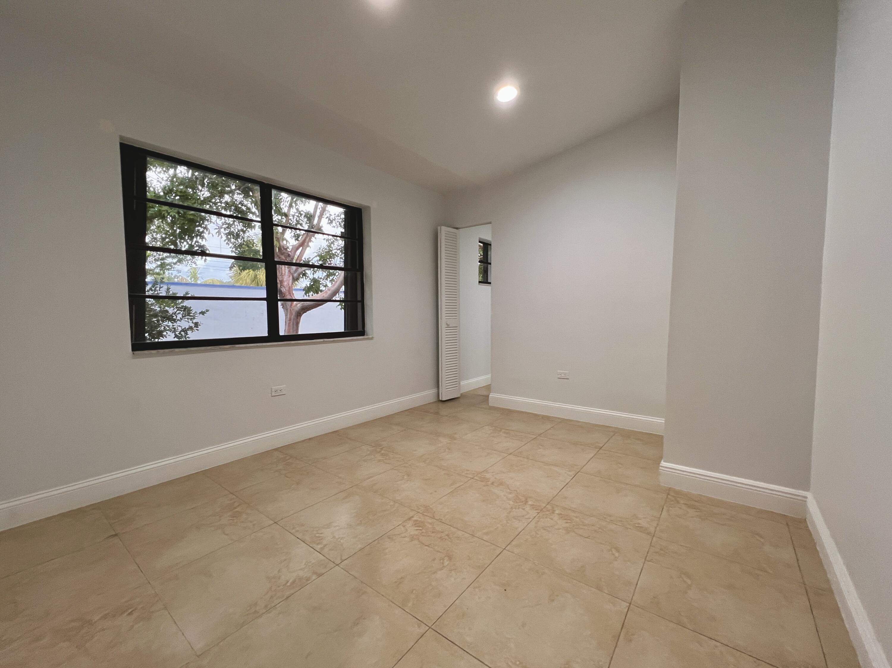 414 Coconut Drive Key Largo, FL 33037 - Photo 22 of 36 an empty room with windows