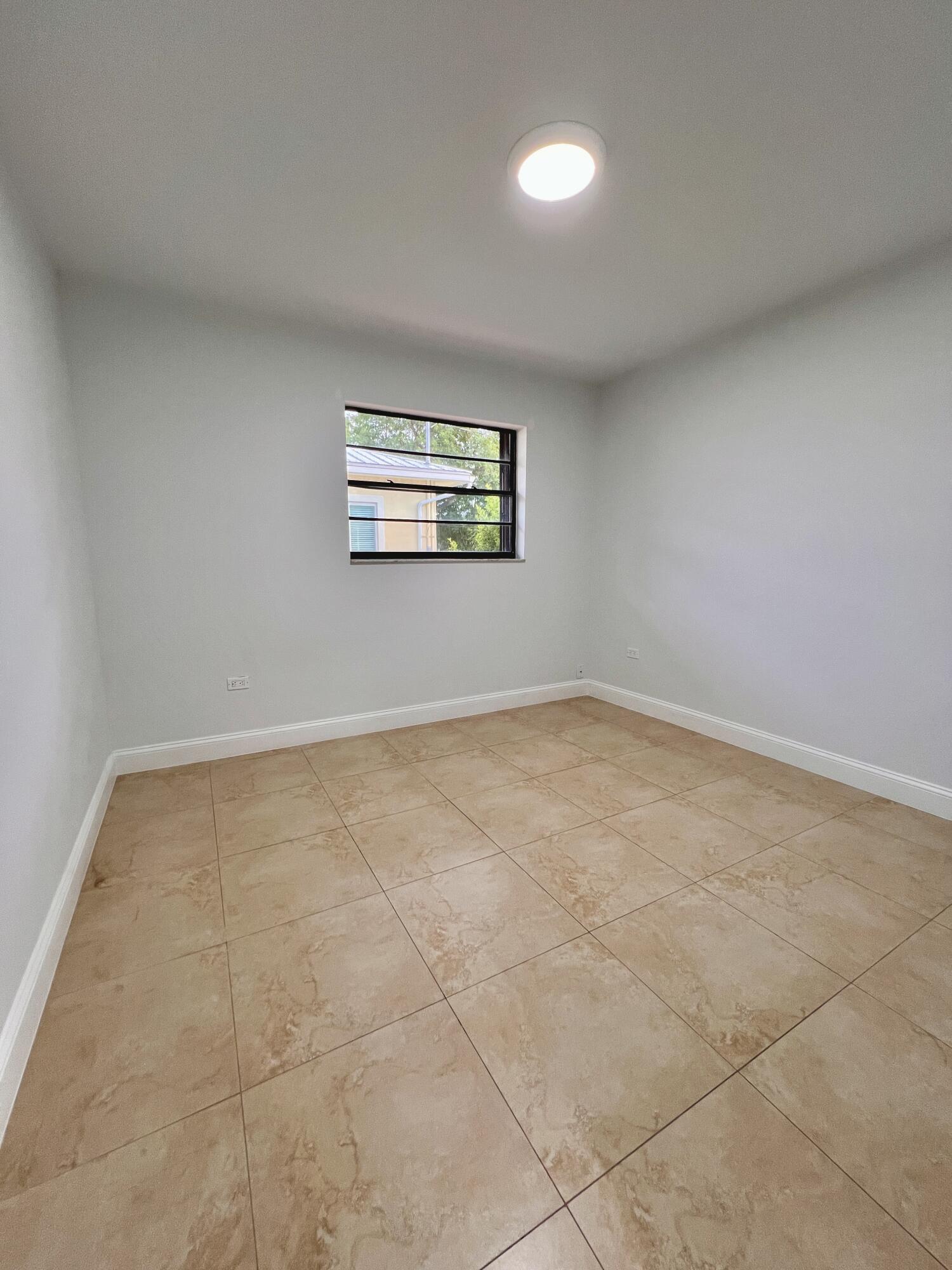 414 Coconut Drive Key Largo, FL 33037 - Photo 26 of 36 an empty room with windows