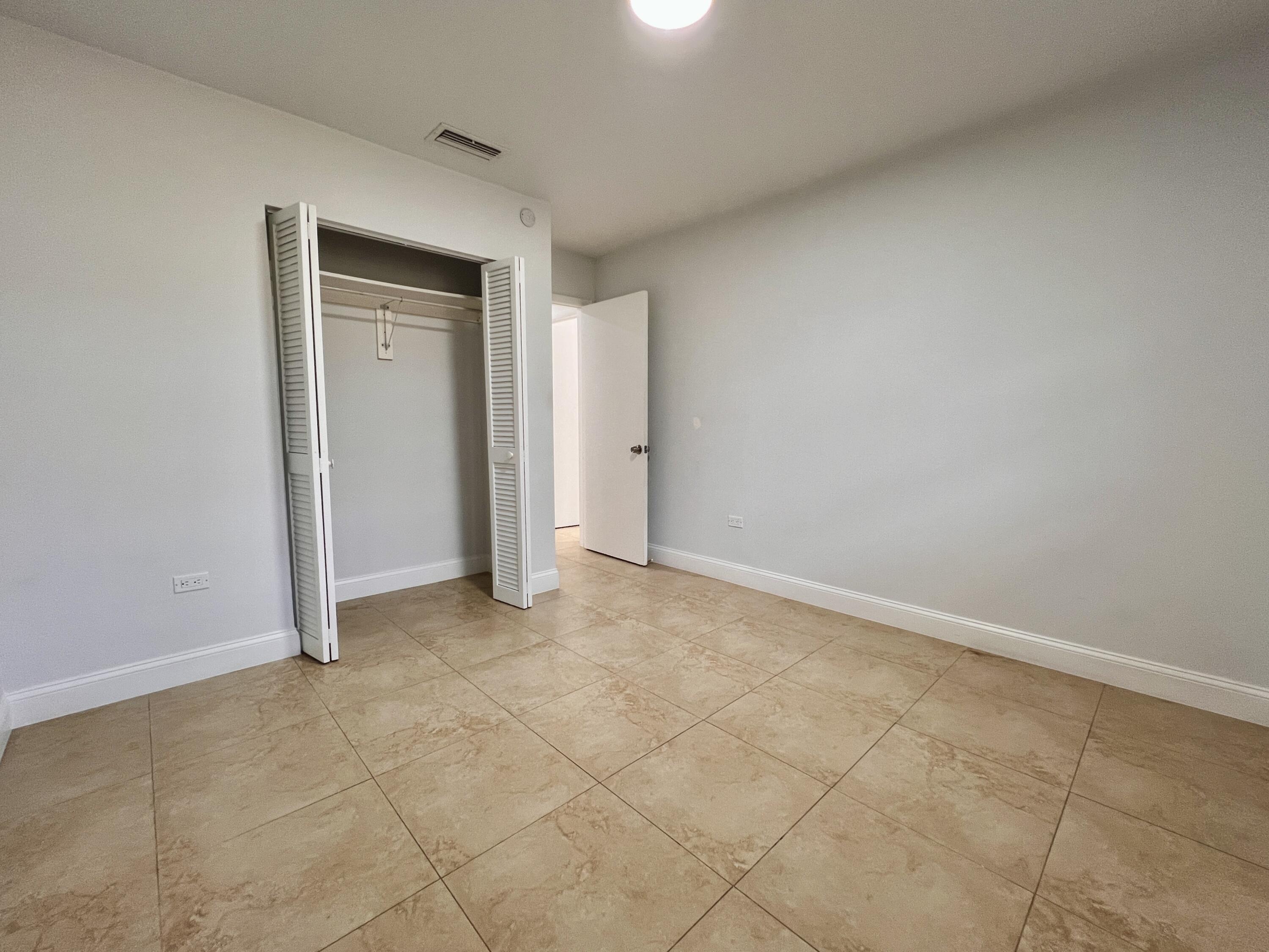 414 Coconut Drive Key Largo, FL 33037 - Photo 27 of 36 an empty room with a natural light