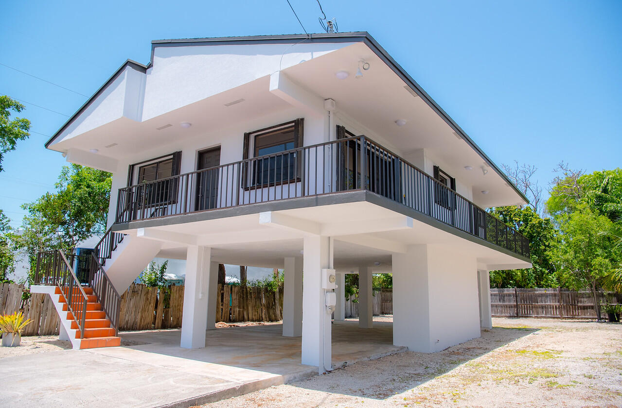 414 Coconut Drive Key Largo, FL 33037 - Photo 3 of 36 a front view of a house with a yard
