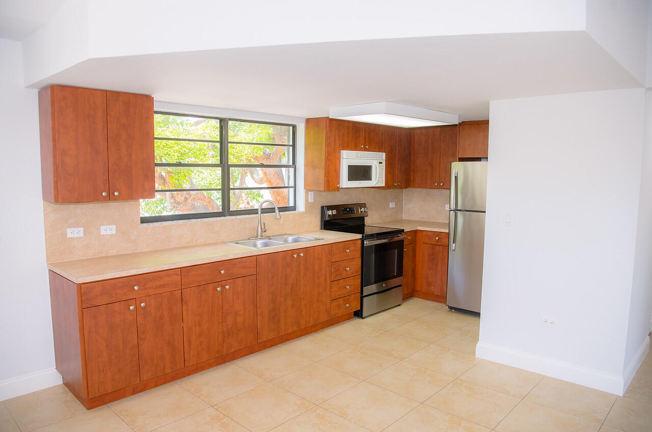 414 Coconut Drive Key Largo, FL 33037 - Photo 6 of 36 a kitchen with stainless steel appliances a sink and a stove