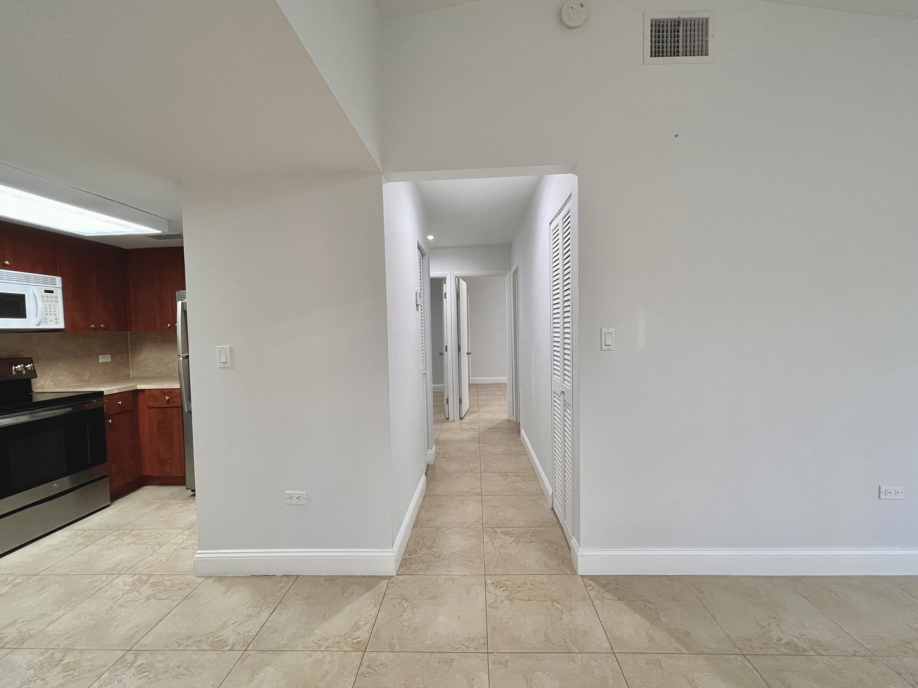 414 Coconut Drive Key Largo, FL 33037 - Photo 8 of 36 a view of a hallway to rooms and kitchen