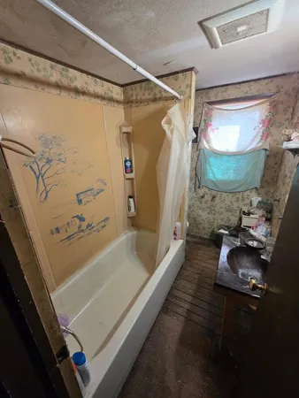a bathroom with a tub and shower