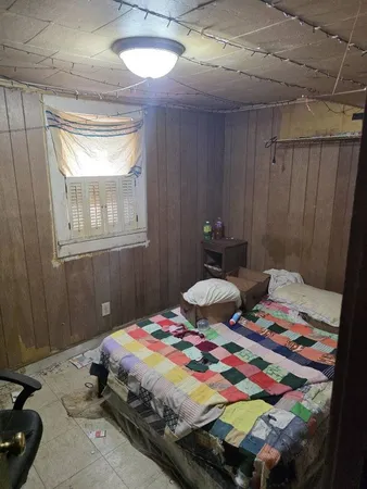 a bedroom with a bed and a table in it