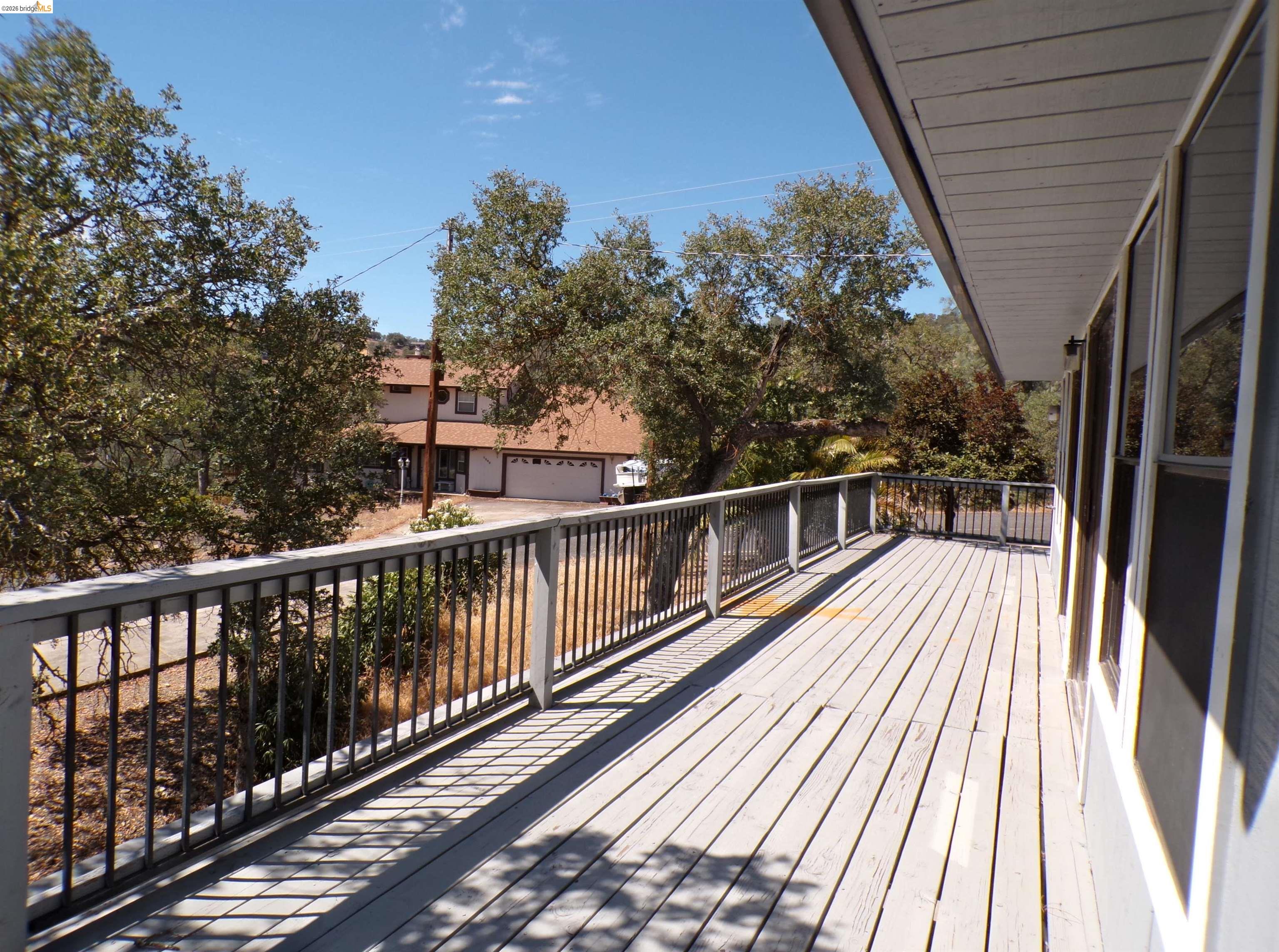 4271 Council Trail Copperopolis, CA 95228 - Photo 32 of 32 Expansive outdoor deck featuring wood-finish flooring and black metal railings