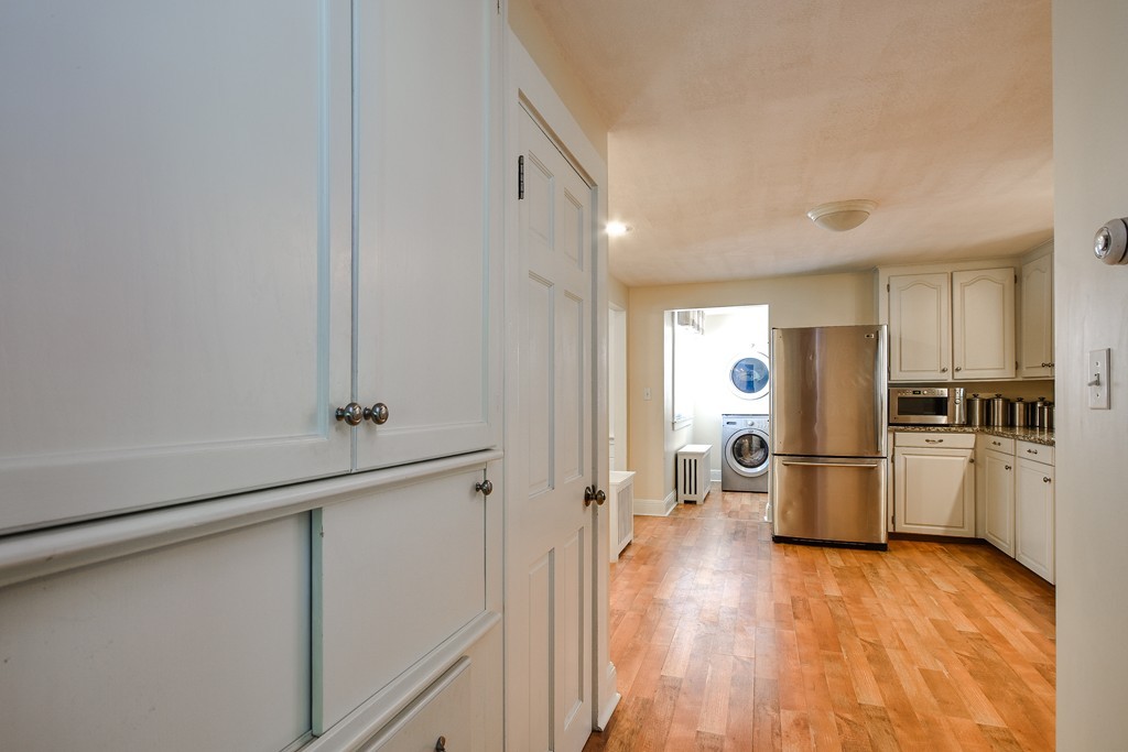 54 Spring Street Hopkinton, MA 01748 - Photo 3 of 22 a kitchen with a refrigerator and a stove top oven
