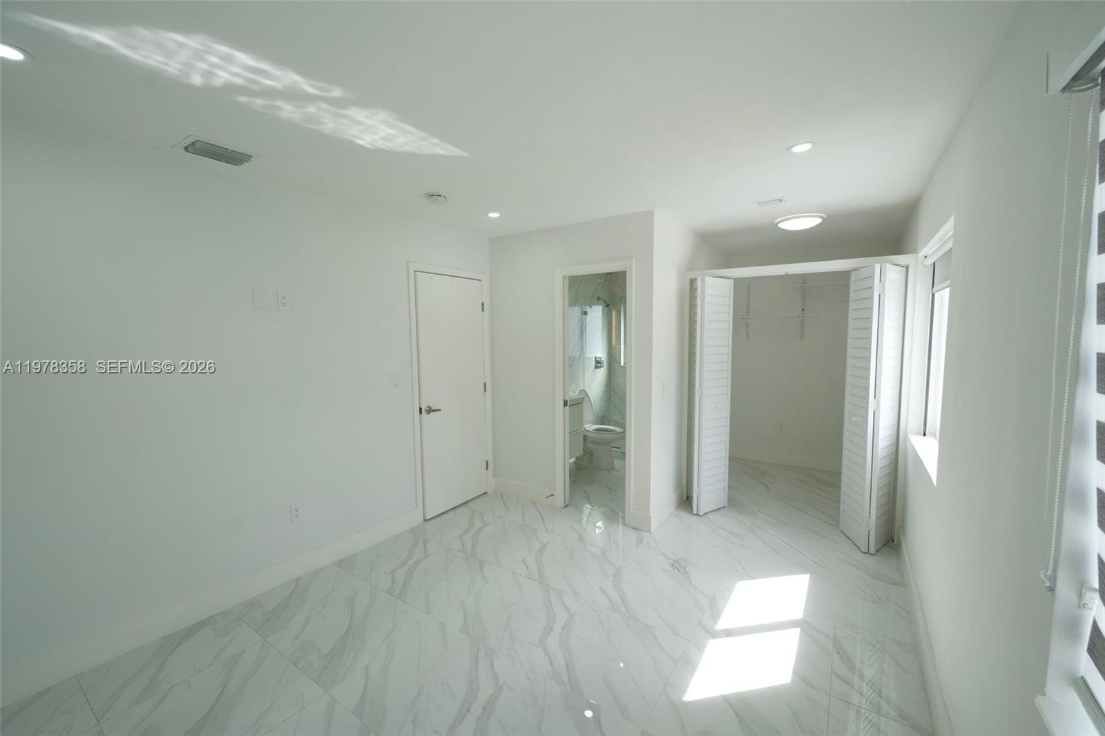 10381 Southwest 32nd Street Miami, FL 33165 - Photo 12 of 38 a bathroom with a shower and a glass door