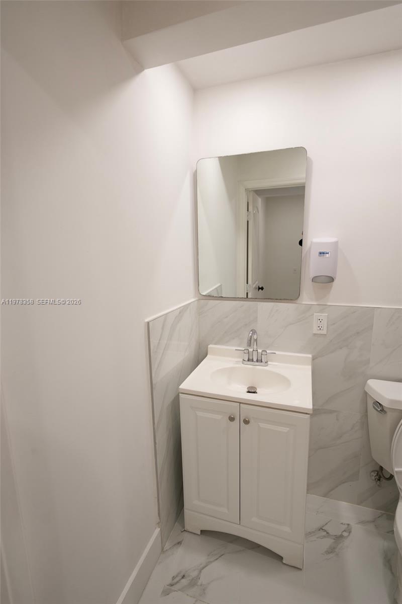 10381 Southwest 32nd Street Miami, FL 33165 - Photo 26 of 38 a bathroom with a toilet sink and mirror