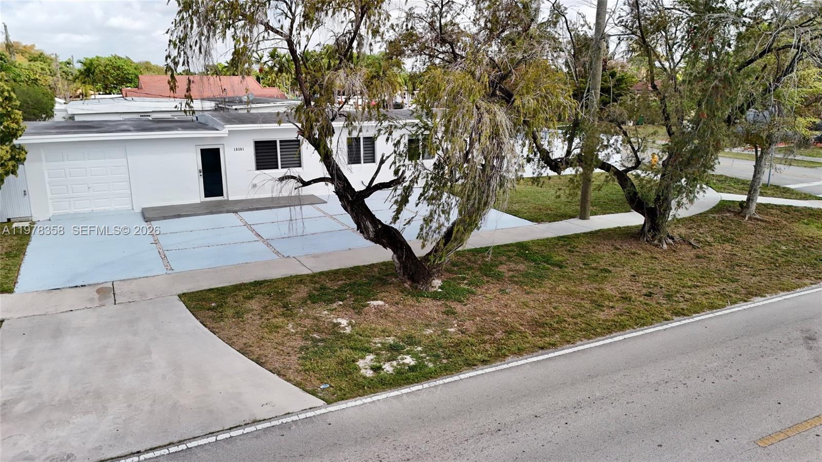 10381 Southwest 32nd Street Miami, FL 33165 - Photo 4 of 38 a view of a yard with plants and trees
