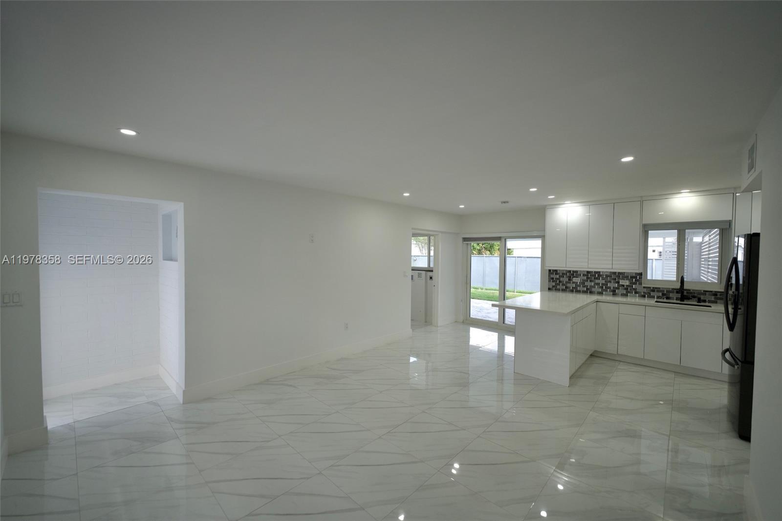 10381 Southwest 32nd Street Miami, FL 33165 - Photo 6 of 38 a view of large windows and a fireplace