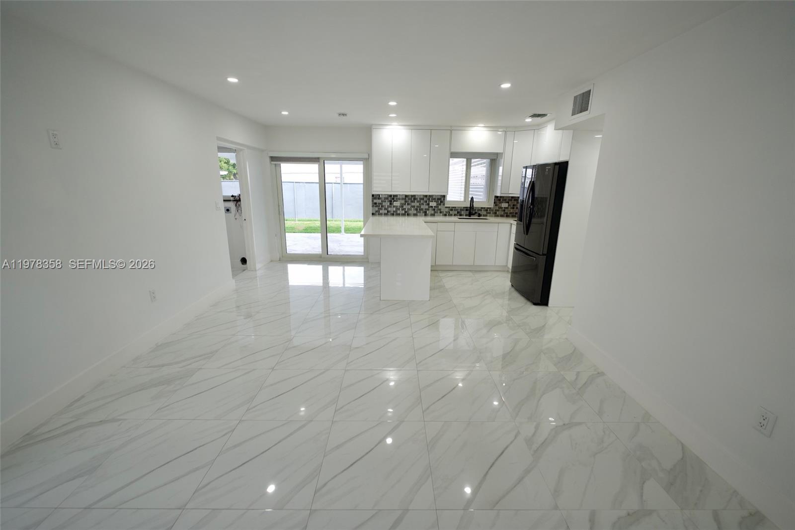 10381 Southwest 32nd Street Miami, FL 33165 - Photo 8 of 38 a view of kitchen with kitchen island white cabinetry and refrigerator