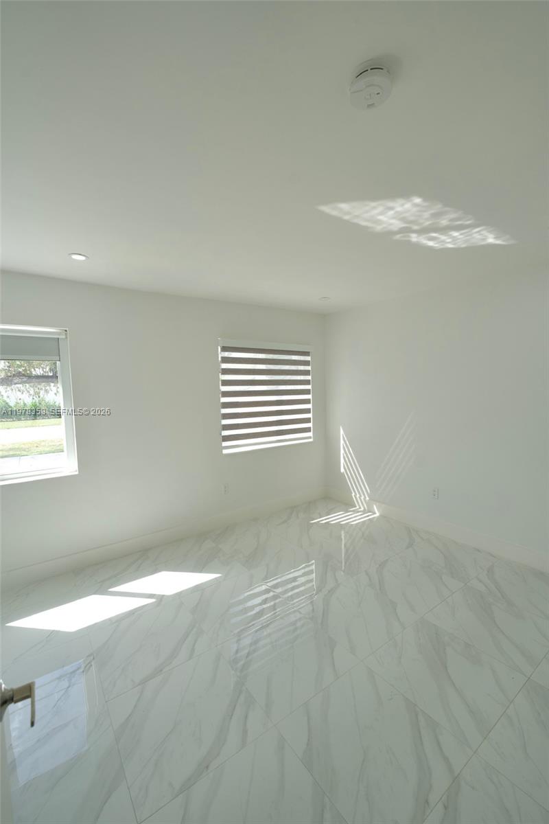 10381 Southwest 32nd Street Miami, FL 33165 - Photo 10 of 38 a view of an empty room with a window