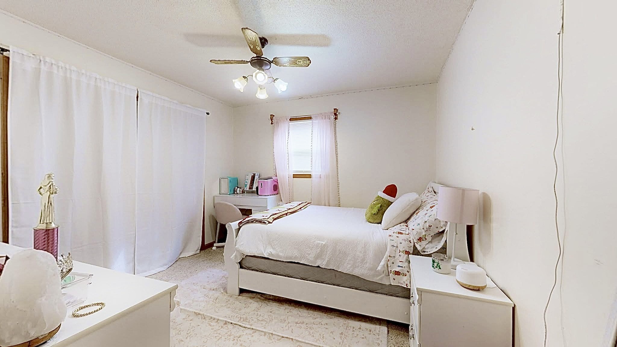 1135 West Mink Branch Road Waynesboro, TN 38485 - Photo 50 of 68 a bedroom with a bed and a chandelier