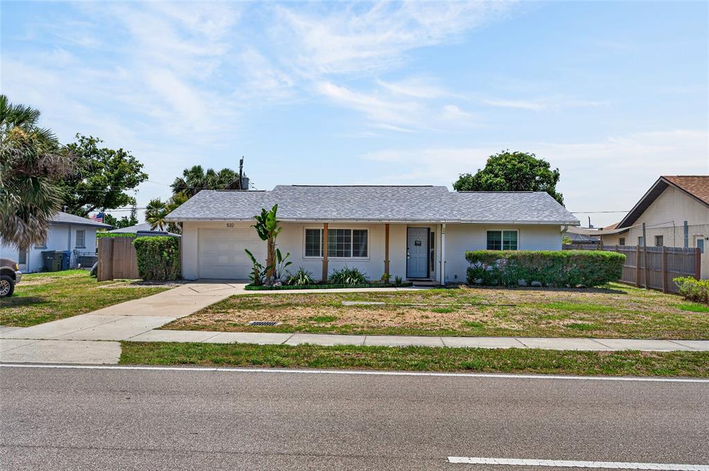 532 Center Road Venice, FL 34285 - Photo 9 of 68 a front view of a house with a garden and yard