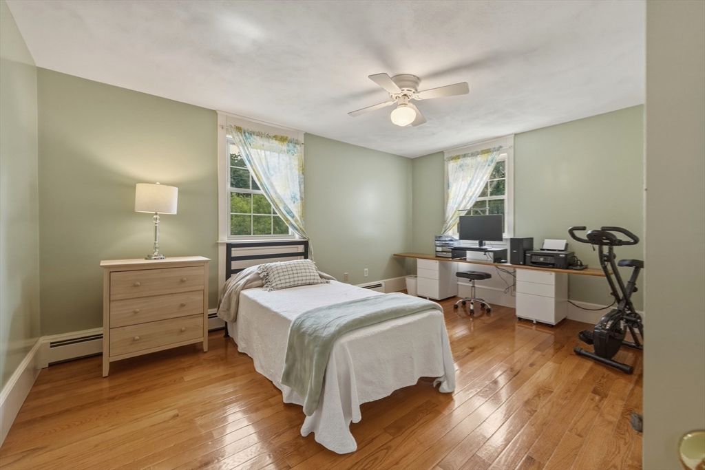 90 Rounsevell Road Tewksbury, MA 01876 - Photo 21 of 42 a bedroom with a bed and a chandelier