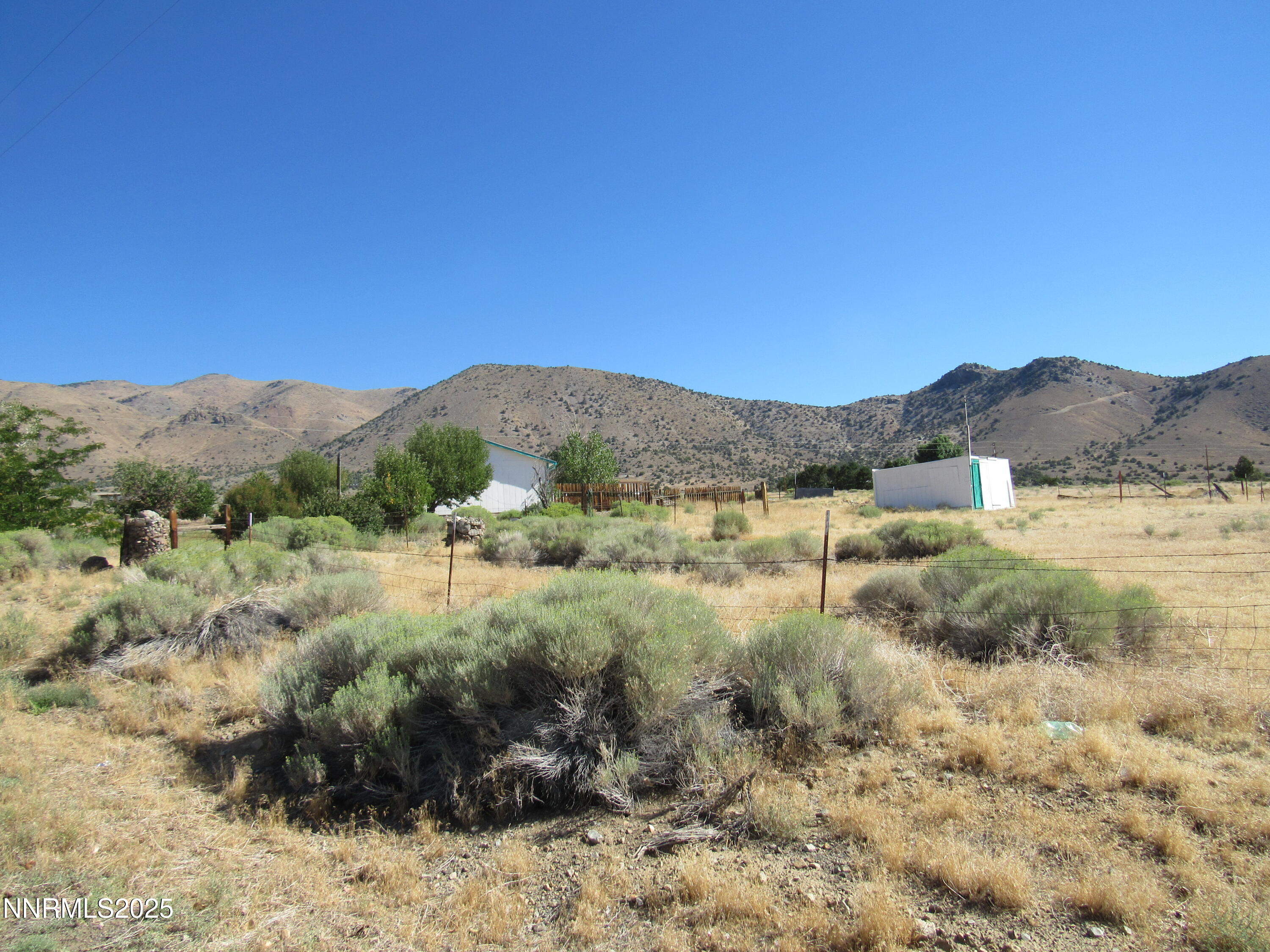 4151 Gray Hills Road Wellington, NV 89444 - Photo 22 of 25 a view of a lush green field with mountains in the background