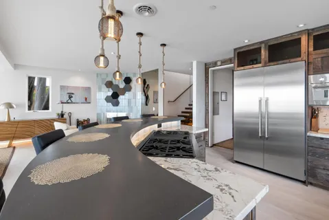 a bedroom with a large bed and a painting on the wall