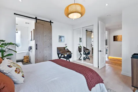 a bedroom with a large bed and a large window