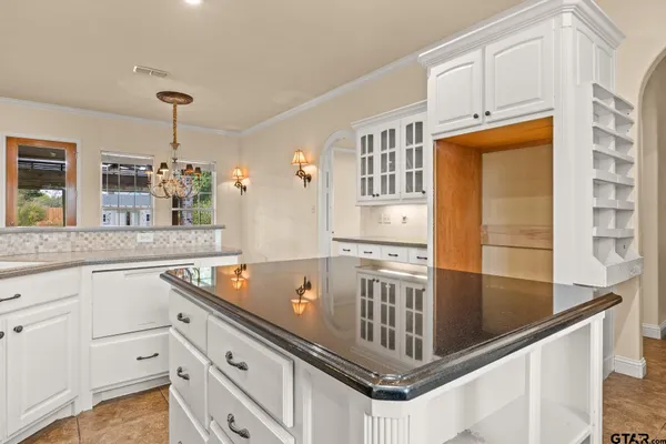 a kitchen with stainless steel appliances granite countertop a sink and cabinets