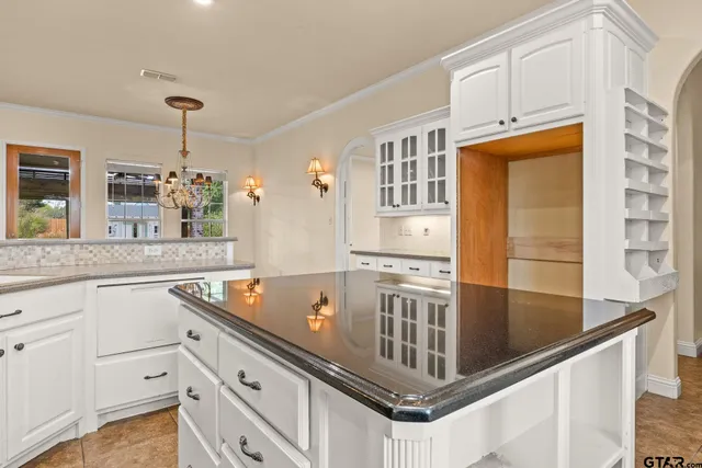 a kitchen with granite countertop a stove and a microwave