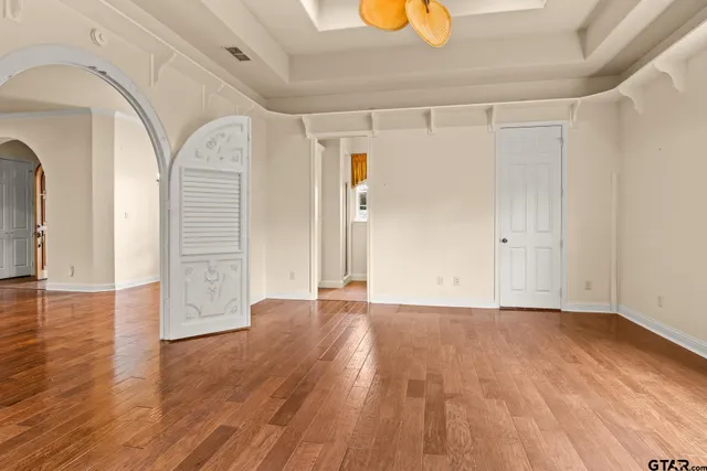 a view of a room with wooden floor
