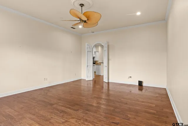 a view of empty room with wooden floor