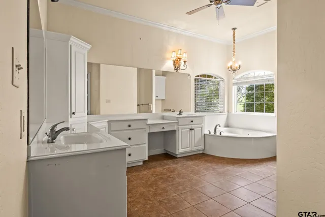 a bathroom with a tub sink and window