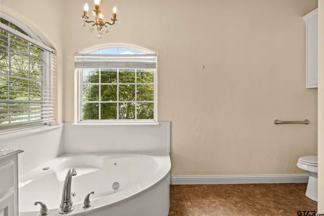 a white toilet sitting next to a shower