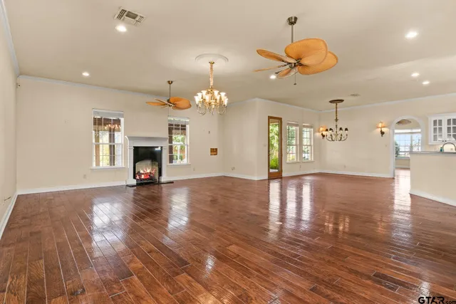 a view of a room with wooden floor and chandelier