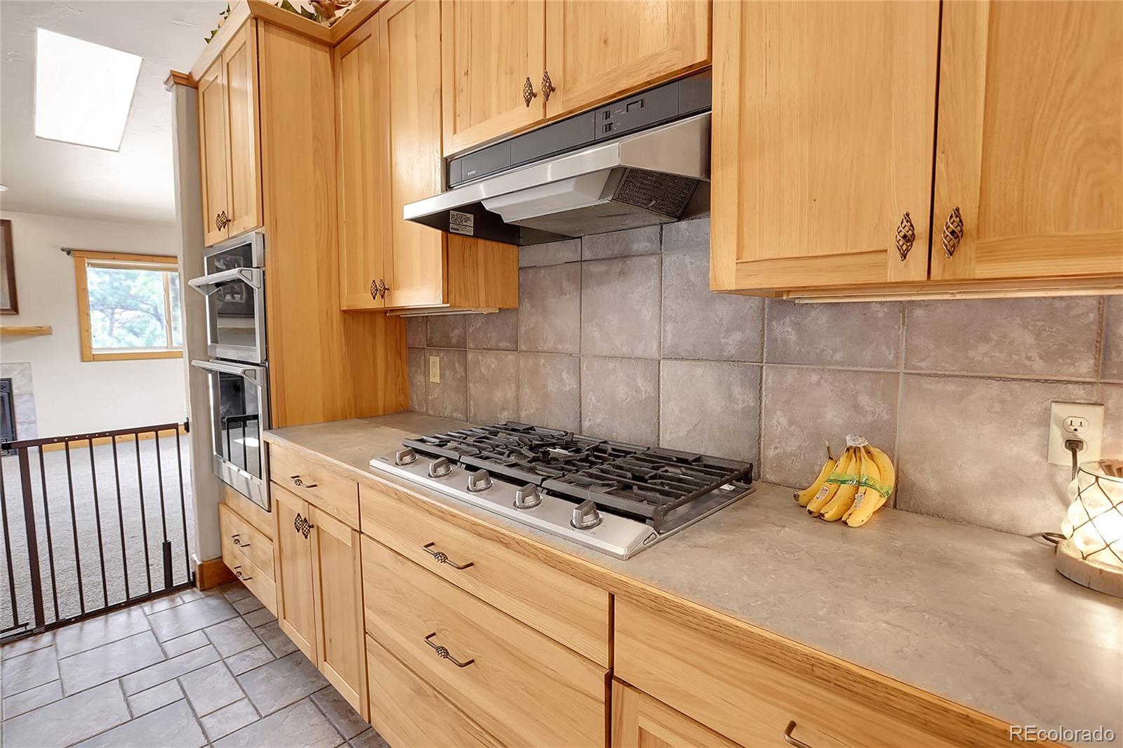 2063 Roland Drive Bailey, CO 80421 - Photo 15 of 49 a kitchen with stainless steel appliances granite countertop a stove a sink and a white cabinets with granite countertops
